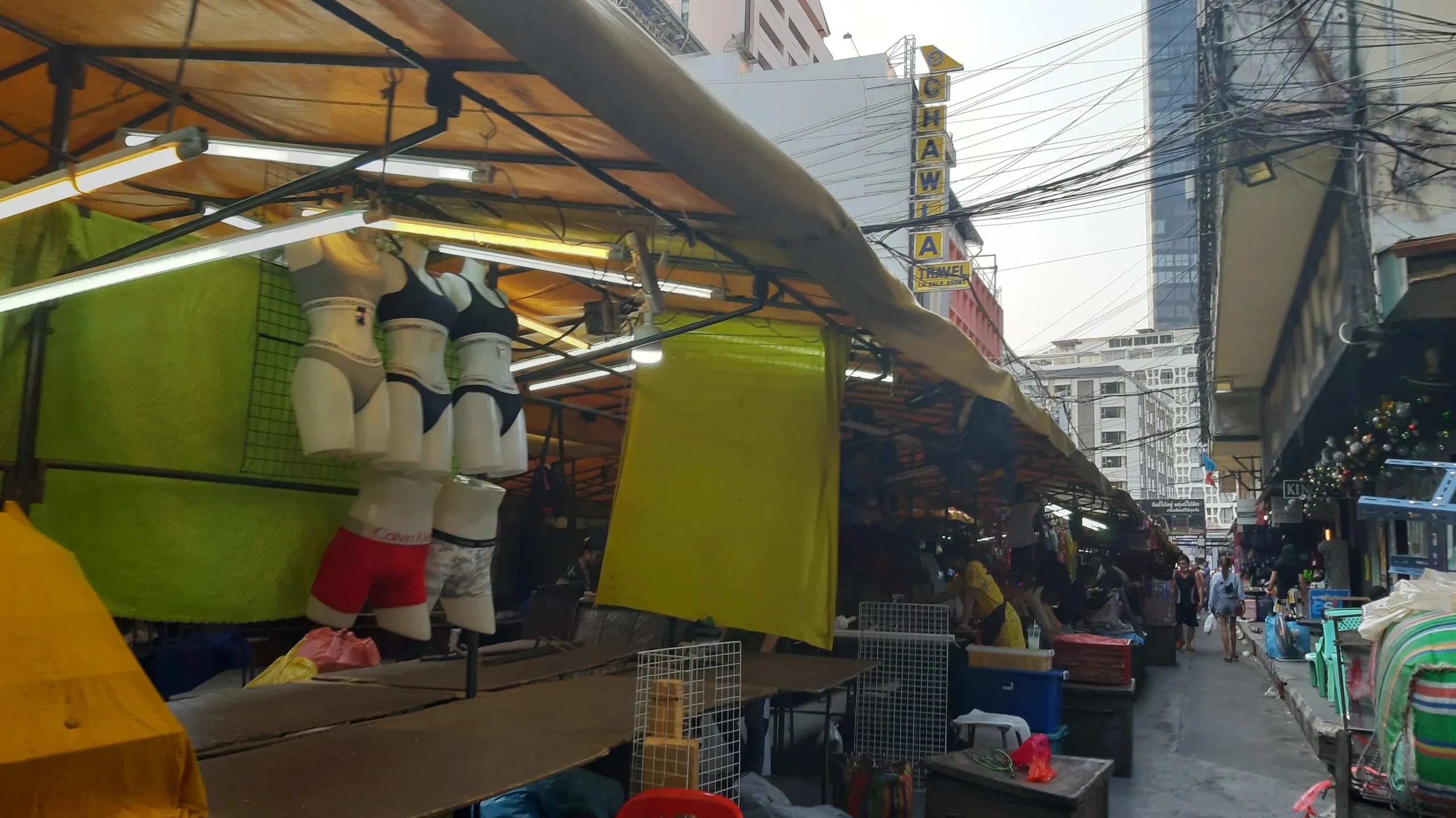 Night market stalls set up along Patpong Soi 1 after dark, awnings lit from below.